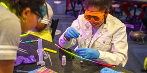 Girls performing a colorful experiment.